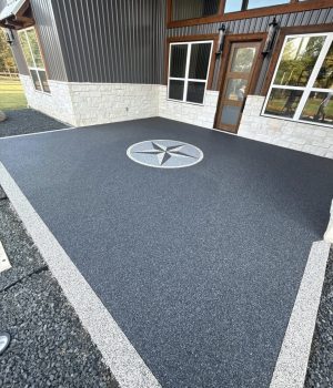 Vuba Stone patio in dark gray with a light gray border plus a large decorative Lone Star in a circle